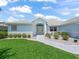 Charming front exterior with manicured lawn, complemented by beautiful landscaping at 17755 Se 117Th Cir, Summerfield, FL 34491