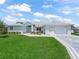 Inviting single-story home featuring a light blue exterior, lush green lawn and a spacious two-car garage at 17755 Se 117Th Cir, Summerfield, FL 34491