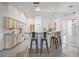 Spacious kitchen featuring light wood cabinets, a breakfast bar and open access to the living areas at 17755 Se 117Th Cir, Summerfield, FL 34491