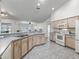 Well-lit kitchen featuring a stainless steel sink, neutral countertops and light wood cabinets with appliances at 17755 Se 117Th Cir, Summerfield, FL 34491