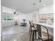 Open-concept living room featuring a breakfast bar, tile flooring, and natural light at 17755 Se 117Th Cir, Summerfield, FL 34491