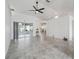 Bright living room featuring tile floors, a modern ceiling fan, and sliding glass doors leading to the lanai at 17755 Se 117Th Cir, Summerfield, FL 34491