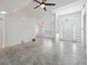 Spacious living room with neutral tile flooring, high ceilings, and a modern ceiling fan at 17755 Se 117Th Cir, Summerfield, FL 34491