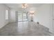 Bright living room boasts neutral tones, tile floors, ceiling fan, and sliding glass door access to enclosed patio at 17755 Se 117Th Cir, Summerfield, FL 34491