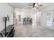 Open concept living area with tile floors, ceiling fan, and connecting kitchen at 17755 Se 117Th Cir, Summerfield, FL 34491