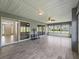 Screened-in patio with wood-look tile, and access to home through sliding glass doors at 17755 Se 117Th Cir, Summerfield, FL 34491