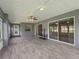 Large screened-in patio with tile flooring, ceiling fan, and access to the backyard at 17755 Se 117Th Cir, Summerfield, FL 34491