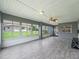 Screened-in patio with wood-look tile flooring and views of the backyard at 17755 Se 117Th Cir, Summerfield, FL 34491