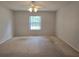 Spacious bedroom featuring a ceiling fan and a large window at 17974 Se 115Th Cir, Summerfield, FL 34491