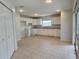 Bright kitchen with tiled flooring, ample cabinet space, and modern white appliances at 17974 Se 115Th Cir, Summerfield, FL 34491