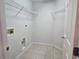 Bright laundry room featuring tile flooring and wire shelving at 17974 Se 115Th Cir, Summerfield, FL 34491