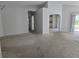 Open-concept living room featuring archways and views to kitchen and back yard at 17974 Se 115Th Cir, Summerfield, FL 34491