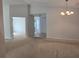 Open living room with neutral tones, carpeted floors and a decorative chandelier at 17974 Se 115Th Cir, Summerfield, FL 34491