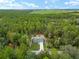 Aerial view of a single-Gathering home surrounded by trees at 23163 Nw Shamrock Ave, Dunnellon, FL 34431