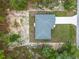 Overhead shot of a home featuring a gray roof, surrounded by trees on a large lot at 23163 Nw Shamrock Ave, Dunnellon, FL 34431