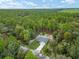 Scenic aerial view of a house surrounded by mature trees on a sprawling property at 23163 Nw Shamrock Ave, Dunnellon, FL 34431