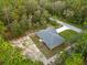 Aerial view of a house with a large, well-maintained backyard and a gray roof at 23163 Nw Shamrock Ave, Dunnellon, FL 34431