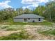 Exterior of the house with a sliding door and an HVAC system sitting on a large lot at 23163 Nw Shamrock Ave, Dunnellon, FL 34431