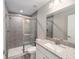 Modern bathroom with tiled shower, frameless glass door, and granite countertop vanity is the perfect place to start your day at 23163 Nw Shamrock Ave, Dunnellon, FL 34431