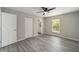 Bedroom featuring wood-look flooring, a large window, and an ensuite bathroom at 23163 Nw Shamrock Ave, Dunnellon, FL 34431