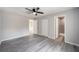 Spacious bedroom featuring a ceiling fan, wood-look floors, a closet and an ensuite bathroom at 23163 Nw Shamrock Ave, Dunnellon, FL 34431