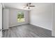 Bedroom featuring wood-look floors, a window and a ceiling fan at 23163 Nw Shamrock Ave, Dunnellon, FL 34431