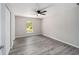 Bright bedroom with wood-look floors, neutral walls, a ceiling fan and a window at 23163 Nw Shamrock Ave, Dunnellon, FL 34431