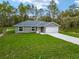 Charming home boasts a well-manicured lawn, attached garage and inviting entrance at 23163 Nw Shamrock Ave, Dunnellon, FL 34431