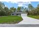 A single-story home with a well-manicured lawn, concrete driveway, and an attached two-car garage at 23163 Nw Shamrock Ave, Dunnellon, FL 34431