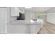 Open-concept kitchen boasts modern white cabinets, sleek countertops, and stainless steel appliances, perfect for culinary enthusiasts at 23163 Nw Shamrock Ave, Dunnellon, FL 34431