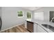 Kitchen area with a granite countertop, stainless steel dishwasher, and natural light at 23163 Nw Shamrock Ave, Dunnellon, FL 34431