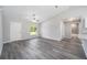 Living room area featuring gray wood-look floors, fresh paint, and natural light at 23163 Nw Shamrock Ave, Dunnellon, FL 34431