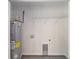 A utility room with washer/dryer hookups, a water heater and wire shelving at 23163 Nw Shamrock Ave, Dunnellon, FL 34431