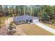 Beautiful one-story house boasting a paved driveway, attached garage, complemented by a freshly painted exterior at 24144 Nw Water Oak Ave, Dunnellon, FL 34431