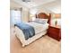 Cozy bedroom features carpeted floor, natural light, and dark wood furnishings at 3023 Charlevoix St, The Villages, FL 32163