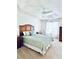 A tranquil bedroom includes a tray ceiling with ceiling fan at 3023 Charlevoix St, The Villages, FL 32163