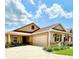 Charming single-story home featuring a well-manicured lawn and colorful landscaping with red shutters, and a red roof at 3023 Charlevoix St, The Villages, FL 32163