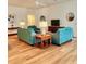 Bright living room with hardwood floors, ceiling fan, and comfortable seating arrangement at 3023 Charlevoix St, The Villages, FL 32163