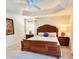 This main bedroom features a tray ceiling and carpeted floors at 3023 Charlevoix St, The Villages, FL 32163