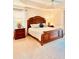 A cozy main bedroom features a large, decorative wood frame bed at 3023 Charlevoix St, The Villages, FL 32163