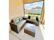 Relaxing patio area featuring a woven sofa, a glass table and views of the garden at 3023 Charlevoix St, The Villages, FL 32163