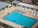 Aerial view of large pool with ample lounge seating and covered pergola at 3023 Charlevoix St, The Villages, FL 32163