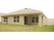 Home exterior featuring fenced backyard, covered patio and well-kept lawn at 356 Se 66Th Ct, Ocala, FL 34472