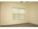 Bright bedroom with a window that lets in natural light and neutral-toned carpet at 356 Se 66Th Ct, Ocala, FL 34472