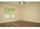 Bedroom featuring wood-look flooring and a large window with light-filtering blinds at 356 Se 66Th Ct, Ocala, FL 34472