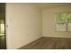 A bright bedroom with light wood flooring and a glass door with backyard access at 356 Se 66Th Ct, Ocala, FL 34472