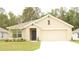 Charming single-story home with a two-car garage, neutral tones, and a well-maintained lawn at 356 Se 66Th Ct, Ocala, FL 34472