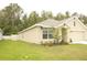 Exterior side view of the home with a 2-car garage and fenced yard at 356 Se 66Th Ct, Ocala, FL 34472