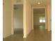 Bright hallway featuring tiled flooring, with views to a living room and entry way at 356 Se 66Th Ct, Ocala, FL 34472