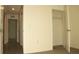 An open hallway with multiple doorways, carpeted floors, and neutrally painted walls at 356 Se 66Th Ct, Ocala, FL 34472
